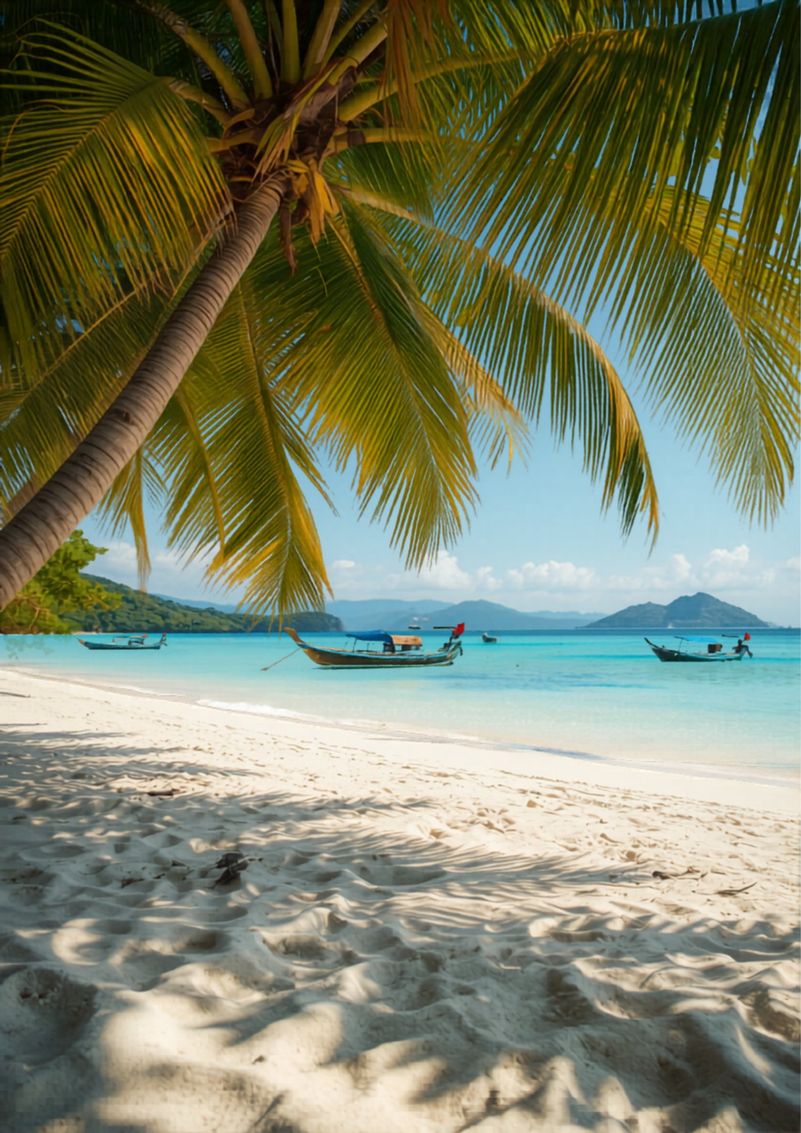 Pristine white sand beach with palm trees and boats in Phu Quoc